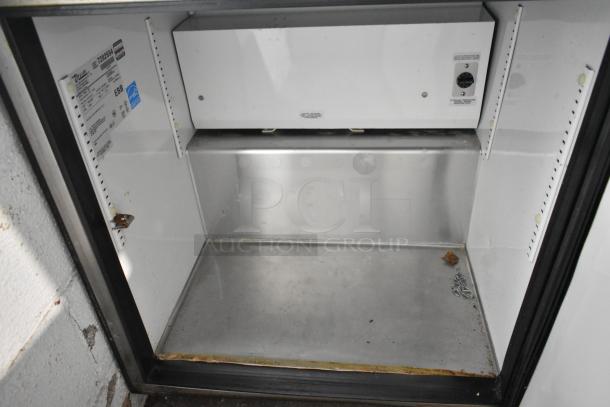 True TUC-27 stainless steel undercounter cooler, commercial casters, 115V, interior view showing condition and labels.