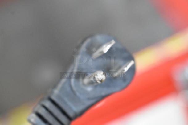 Blurry image of an electrical plug, possibly for the XS110F Metal Chest Freezer Merchandiser, 115 Volts, 1 Phase.