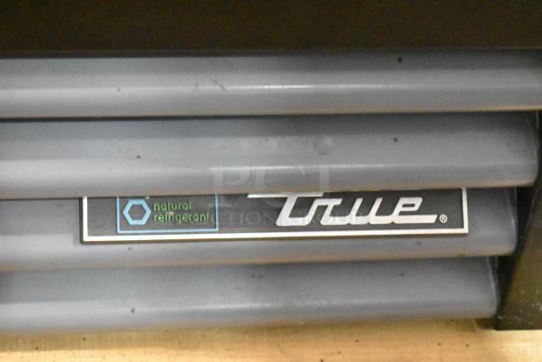 2021 True GDM-12-HC reach-in cooler with poly-coated racks, 115V, 1-phase, natural refrigerant label visible.