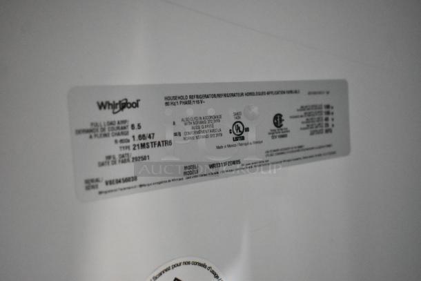 Label showing Whirlpool WRT311FZDM05 model details on a scratch and dent stainless steel cooler with freezer, 115V, 1 phase.