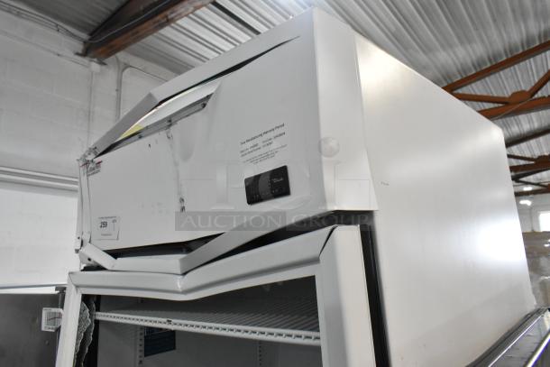 2021 True TSCI-600R-G-PH reach-in cooler with visible dents, one glass door, label indicating 115 volts, 1 phase.