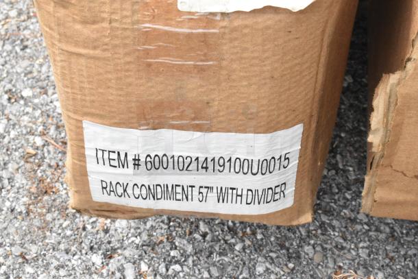 Cardboard box displaying label: "ITEM # 6001021419100U0015 RACK CONDIMENT 57" WITH DIVIDER", part of auction lot.