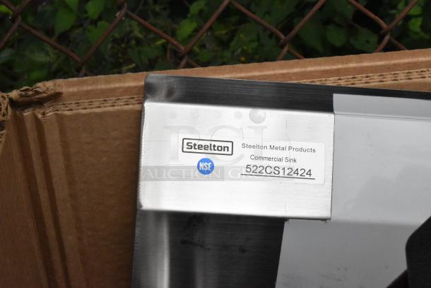 Steelton 522CS12424 stainless steel sink tag, NSF certified, corner view in cardboard box.