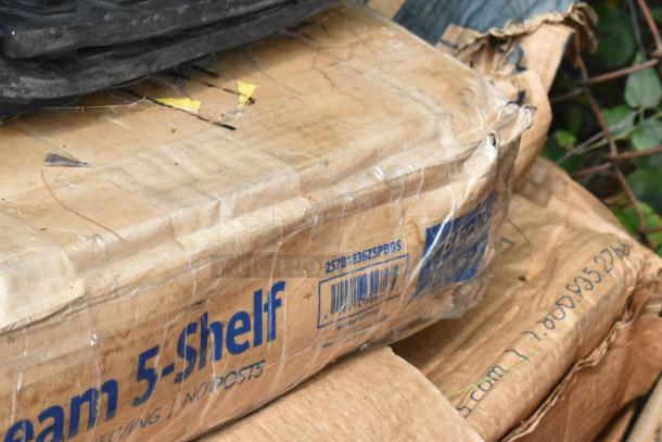 Cardboard box containing Lavex 257B1836Z5PBBS black Z-beam shelves. Visible wear and tape on packaging, barcode present.