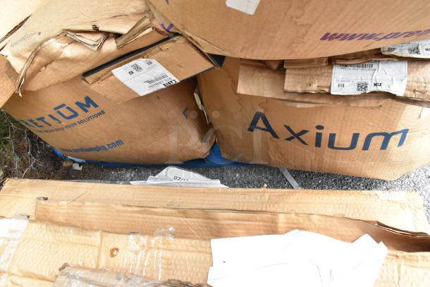 Cardboard boxes labeled "Axium" and "Kason" with visible shipping labels, suggesting new items inside. Boxes show some wear.