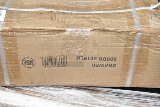 Cardboard box with visible label, "600DR2015LK," indicating a new Regency self-closing drawer, scratched and dented.