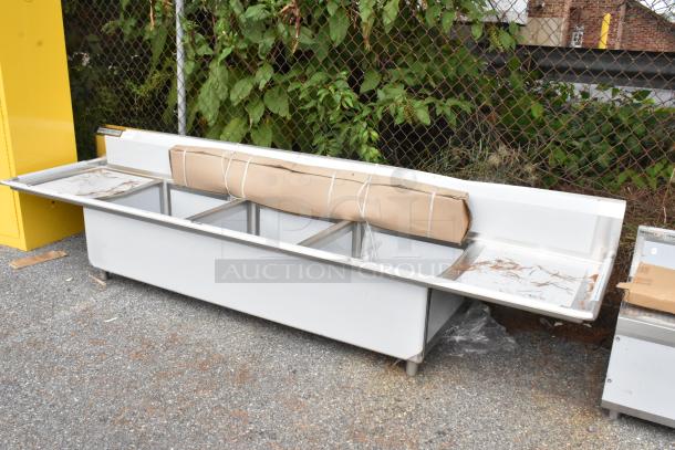 Regency 600S3242424S 124" stainless steel sink, 3 compartments, 2 drainboards, brand new, minor scratches and dents visible.