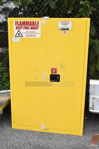 Brand new yellow metal 2-door cabinet with scratch and dent. Flammable warning, labeled "Eagle." Keep fire away sign.