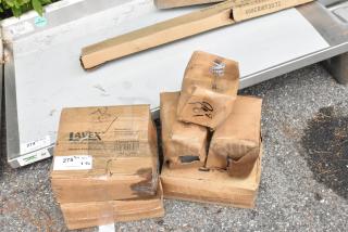 Boxes of Lavex scratch and dent stainless steel items, some damaged. Includes C-fold towel and liquid soap dispensers.