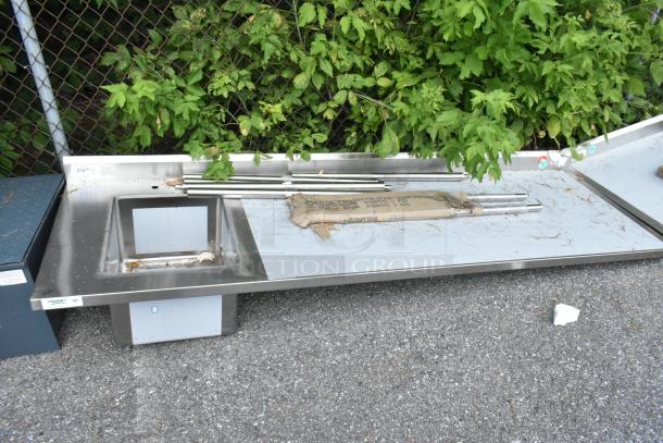 BRAND NEW Regency 600ST3096L stainless steel table with single bay sink, minor scratches, includes metal rods and packaging.