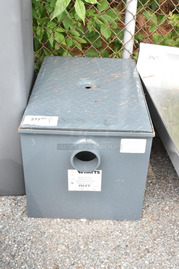 Brand new Watts WD-20 Grease Interceptor, 40 lb. capacity, scratch and dent condition, inlet marking visible.