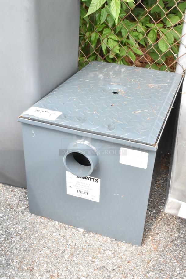 Brand new Watts WD-20 Grease Interceptor, 40 lb. capacity, gray, scratch and dent condition, with inlet label visible.