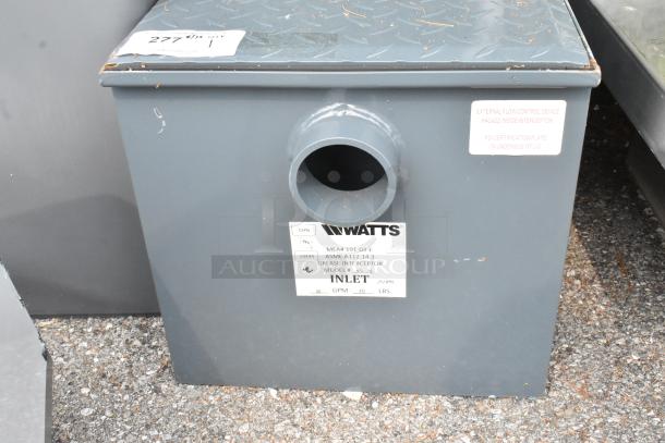 Brand new Watts WD-20 grease interceptor, 40 lb. capacity, scratch and dent, with inlet label and certification markings.