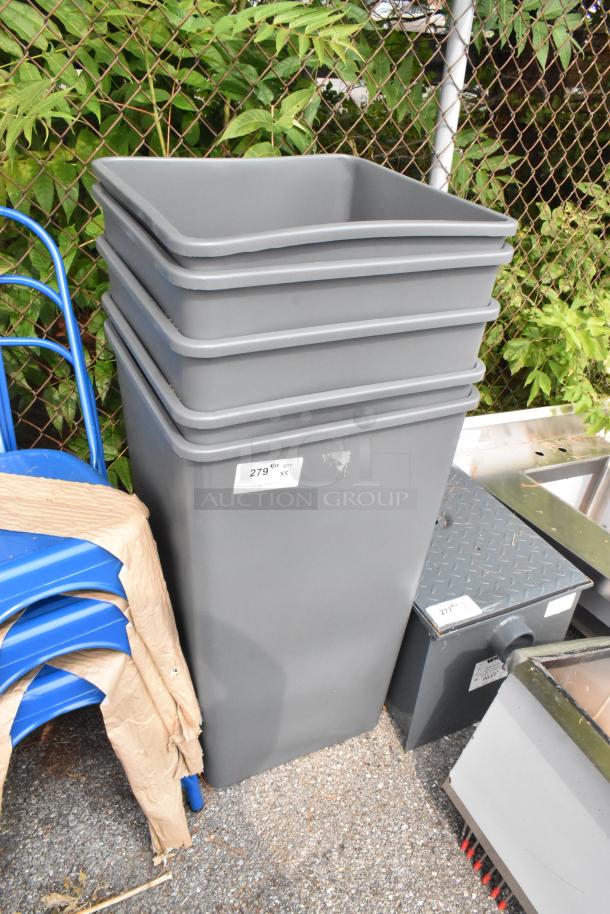 Five new gray poly trash cans with minor scratches and dents, stacked outdoors. Label indicates item number 279.