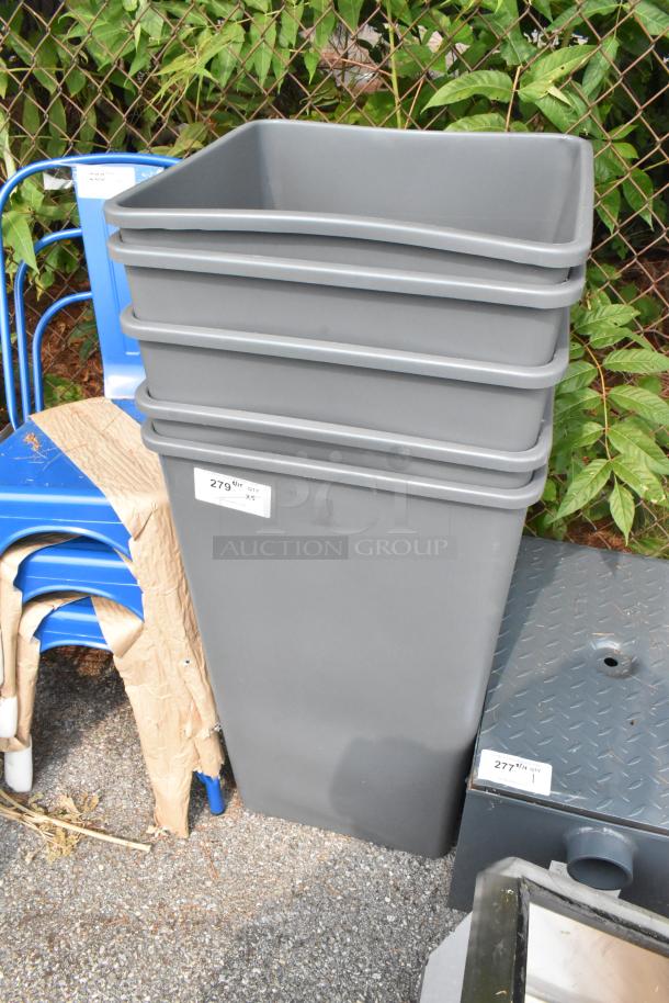 Brand new gray poly trash cans, scratch and dent condition. Stack of five. Quantity label reads "279" and "Qty 5".
