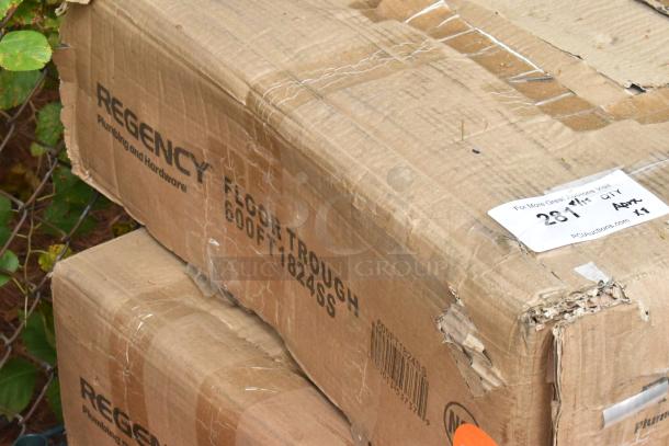 Box labeled Regency 600FT1824SS Floor Trough; scratch and dent condition, visible shipping wear.