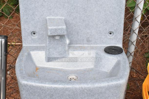 Brand new Lavex gray metal portable sink, visible scratches, and dents. Features a spout, drainage, and side cap.