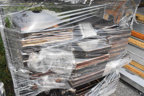 Chrome finish 4-tier wire shelving unit with metal loaf baking pans, wrapped in plastic. Buyer must dismantle; freight charges apply.