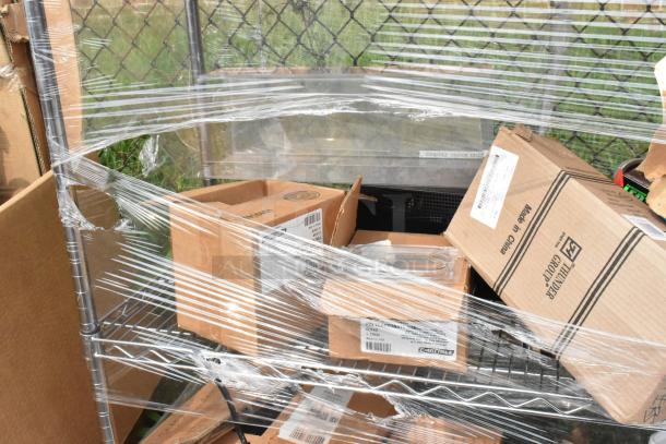 Chrome finish 4-tier wire shelving unit on commercial casters, wrapped with contents including new poly bins. Buyer must dismantle.