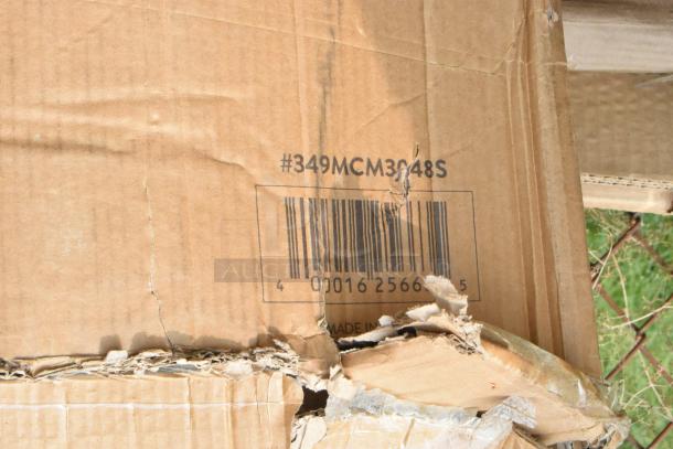Damaged cardboard with #349MCM3048S, Lancaster Table & Seating label, slightly torn, revealing barcode details.