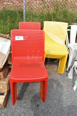 Lancaster red and yellow resin chairs, new, scratch and dent condition, model numbers 427RIOSIDERD, 427RIOSIDEYL, outdoors.