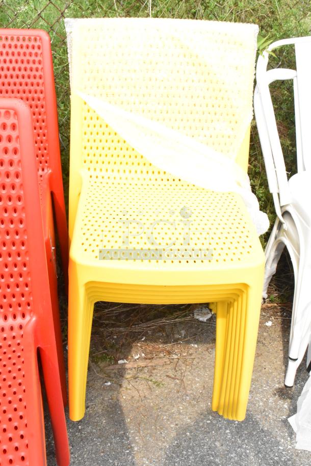 Set of 20 Lancaster Table & Seating Rio resin side chairs, red, orange, yellow. New, scratch and dent condition.