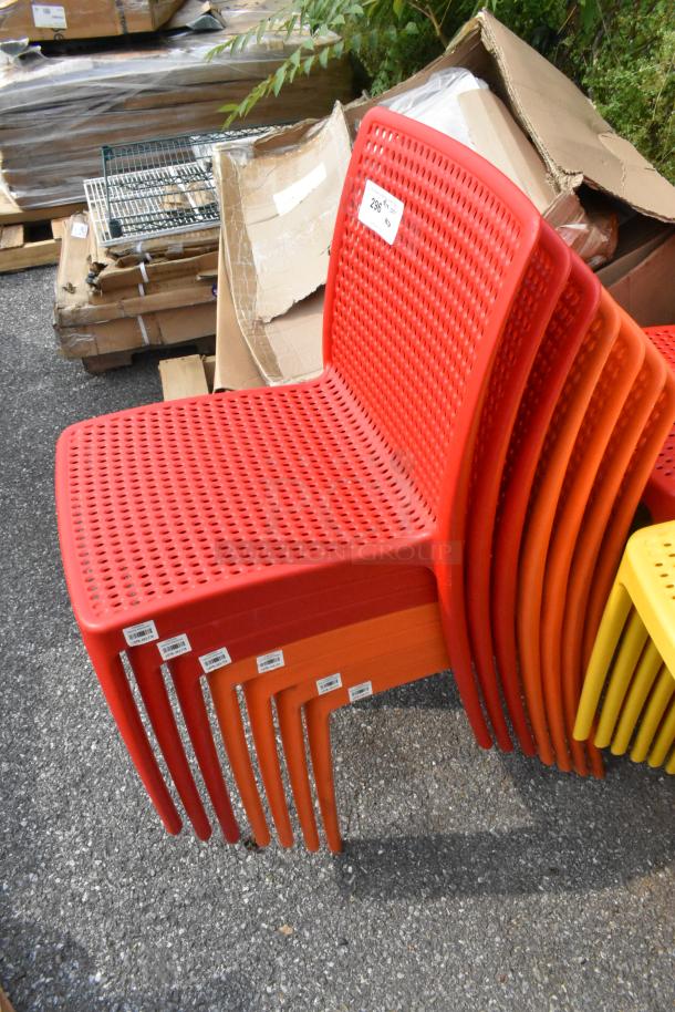 Stack of colorful resin chairs including red, orange, and yellow. Lancaster Table & Seating, new condition, tags visible.
