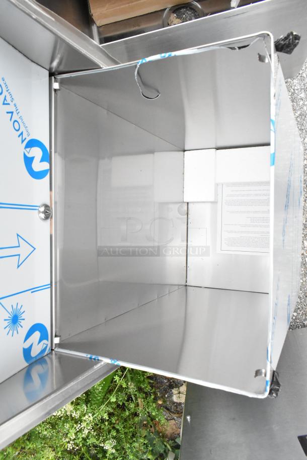 Stainless steel towel dispenser and trash can, brand new with scratches. Protective film partially intact. Nova brand logo visible.
