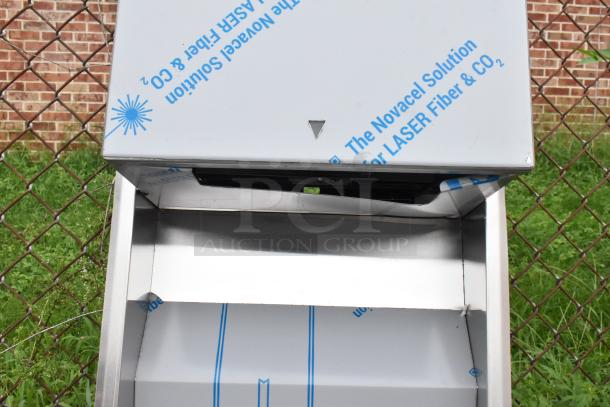 Stainless steel towel dispenser and trash can, new with scratches and dents. Novacel protective film partially intact.