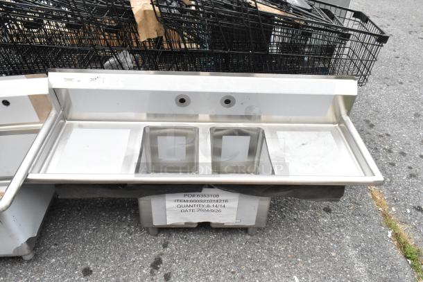 "Regency 600S21014216 Stainless Steel 2 Bay Sink with Dual Drain Boards, scratch and dent condition, no legs shown."