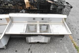 "Regency 600S21014216 Stainless Steel 2 Bay Sink with Dual Drain Boards, scratch and dent condition, no legs shown."