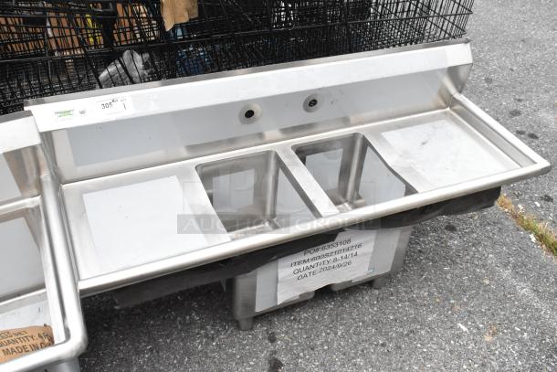 Brand new Regency 600S21014216 stainless steel 2-bay sink, dual drain boards, lacks legs, scratch and dent condition.