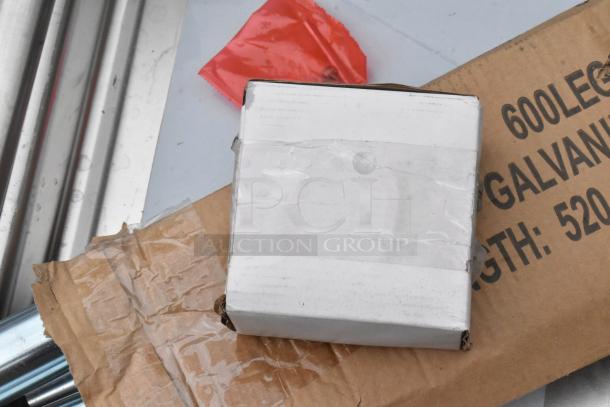Steelton 522CS11818N stainless steel single bay sink, new scratch and dent, in packaging with accessories visible.