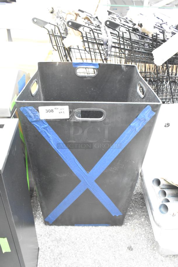 Black trash can with blue tape markings, new condition, slight dents. Label indicates item number 308, quantity 3.