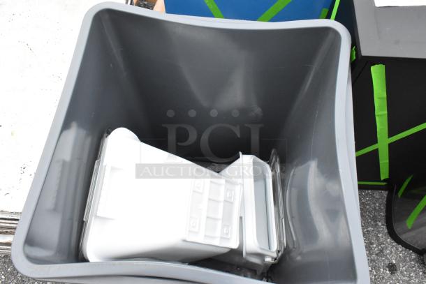 Gray poly trash can with minor scratches and dents. Brand new. Includes white interior components. Auction for two cans.