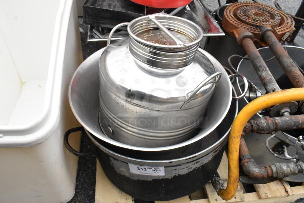 Pallet lot with a variety of items including a red salad spinner, metal pots, burners, and gas hoses, some wear visible.