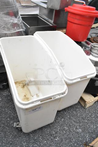 Two white poly ingredient bins on commercial casters, used condition, showing some dirt. Label reads "314 QT XL."