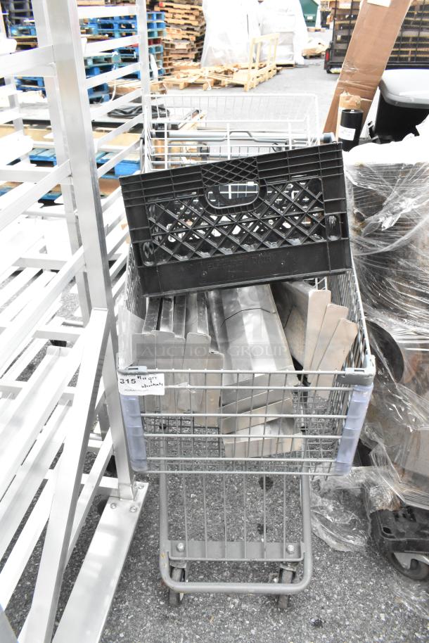Gray shopping cart filled with metal pieces and a black plastic crate. Visible tag marked "315" indicates item lot number.