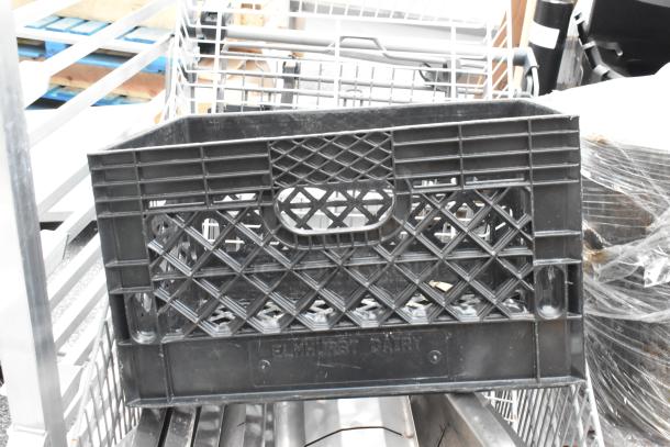 Gray shopping cart with contents, including a black crate marked "Elmhurst Dairy" and various metal items, in used condition.