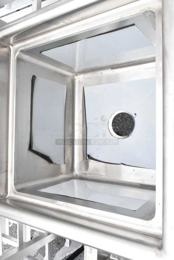 Stainless steel single bay sink, reflective finish, visible drain, sturdy construction, excellent condition.
