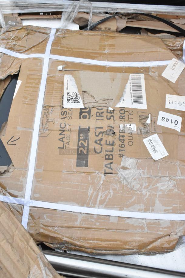 Damaged packaging of mixed kitchen equipment, including Regency grease traps and stainless steel legs. Visible labels and markings.