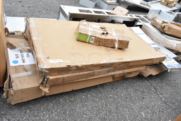 Five boxed scratch-and-dent items, including a tabletop Thermo Form 3048 GRY wood and Steelton stainless steel work table.