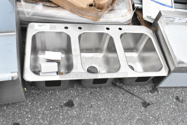 Brand new stainless steel 3 bay drop-in sink with minor scratches. Includes pre-drilled faucet holes and visible label indicating model.