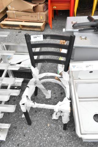 Brand new black metal ladder back dining chair frame, dining height, with visible wrapping, showing minor scratches.