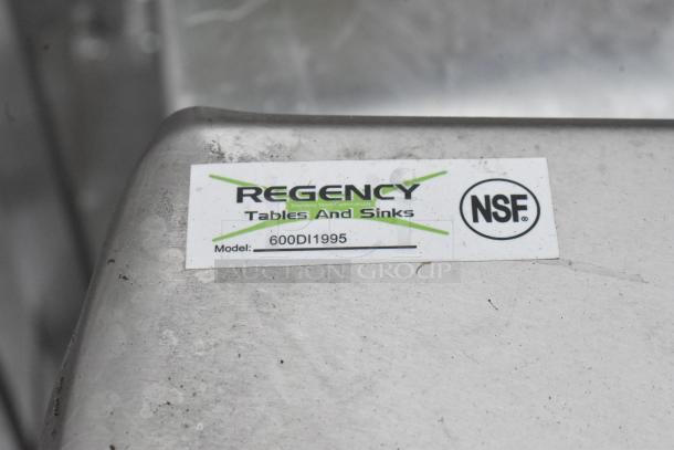 Brand label on Regency 600DI1995 9" x 9" x 5" stainless steel sink, showing model number and NSF certification.