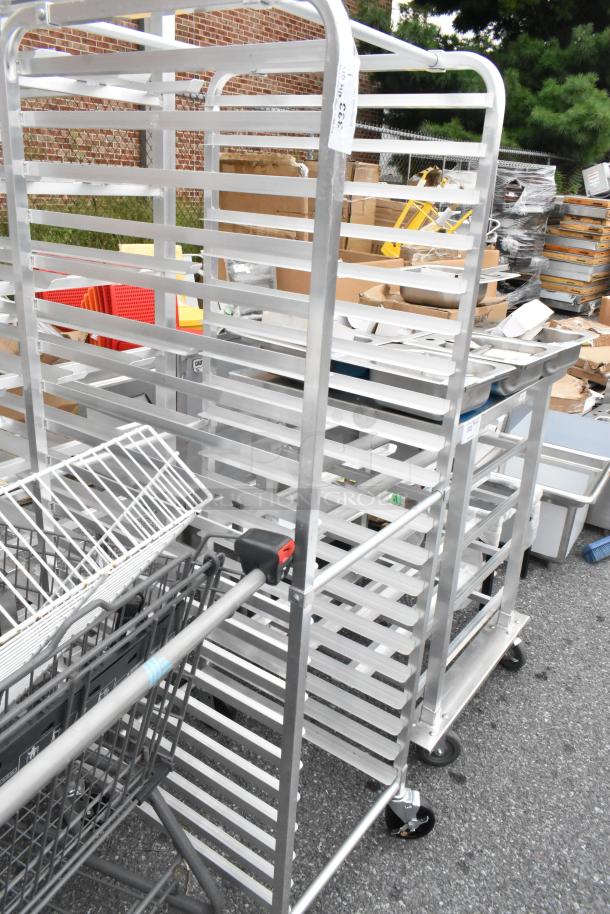 Regency 109RACKECON metal pan transport rack with multiple shelves on commercial casters, used, outdoors.
