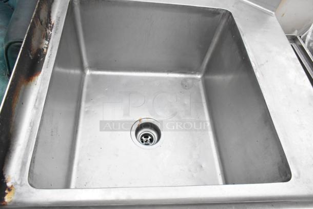 Stainless steel left side dirty side dishwasher table, featuring integral sink, showing signs of wear and rust on edges.
