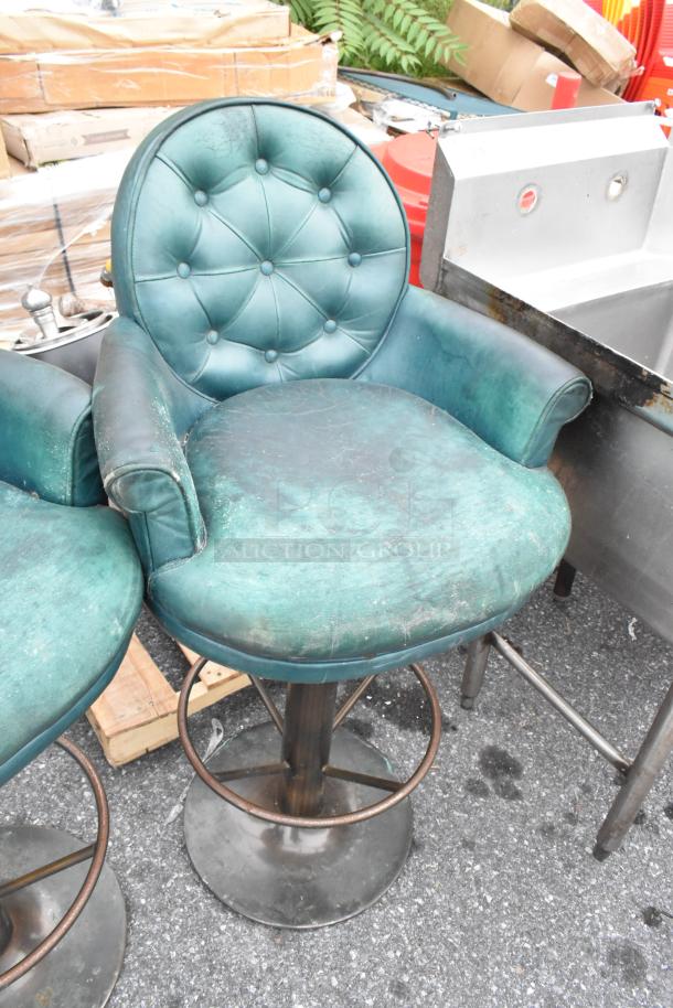 Two bar height chairs with green tufted upholstery, visible wear, metal bases; auction offers two for one bid.