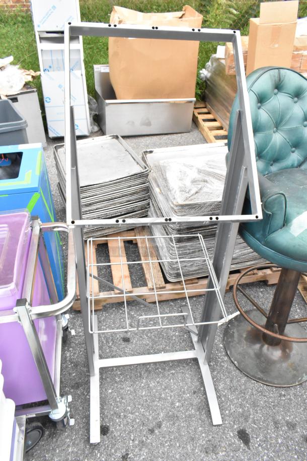Metal sign frame, silver, includes wire shelf. Good condition, ready for signage display. Auction for two pieces.