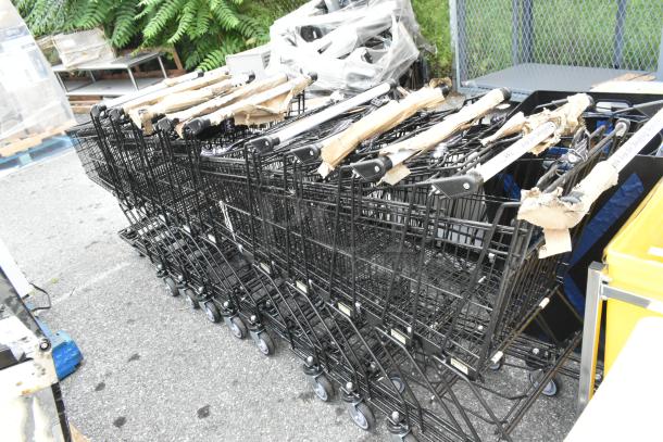 10 metal shopping carts on casters, stacked and wrapped, ready for sale. Durable, good condition. Auction lot of 10.